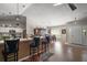 Open floor plan featuring a breakfast bar, dining area, and access to the front door at 4300 Leafway Cir, Leesburg, FL 34748