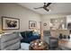 Spacious living room with ample seating, hardwood floors, and open access to the kitchen area at 4300 Leafway Cir, Leesburg, FL 34748
