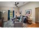 Comfortable living room with plush seating, a modern ceiling fan, and plenty of natural light at 4300 Leafway Cir, Leesburg, FL 34748