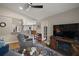Open living room with modern furniture, a TV, and seamless access to the kitchen at 4300 Leafway Cir, Leesburg, FL 34748