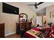 Comfortable main bedroom with dresser, television, and access to other rooms at 4300 Leafway Cir, Leesburg, FL 34748