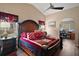 Elegant main bedroom with a large bed, unique decor, and an adjoining room at 4300 Leafway Cir, Leesburg, FL 34748