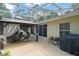 Covered patio featuring a gazebo with curtains, outdoor seating, and a grill, perfect for relaxation and entertaining at 4300 Leafway Cir, Leesburg, FL 34748