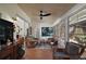 Bright sunroom with comfortable seating, lots of windows, and a ceiling fan at 4300 Leafway Cir, Leesburg, FL 34748