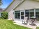 Charming backyard with a patio, rocking chair, and grill, perfect for outdoor relaxation and entertaining at 4520 Eaglewood Dr, Leesburg, FL 34748