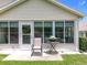 Relaxing backyard patio area with a rocking chair and grill, ideal for enjoying the outdoors at 4520 Eaglewood Dr, Leesburg, FL 34748