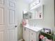 Cozy bathroom featuring a modern vanity with storage, a mirrored cabinet, and decorative towels at 4520 Eaglewood Dr, Leesburg, FL 34748