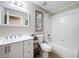 Bright bathroom with a shower and tub combination, a white vanity, and decorative beach themed artwork at 4520 Eaglewood Dr, Leesburg, FL 34748