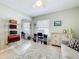 Bedroom featuring a mirrored closet, desk, and comfortable seating area at 4520 Eaglewood Dr, Leesburg, FL 34748