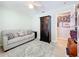 Bedroom with light green walls, a sofa and a dark wood cabinet at 4520 Eaglewood Dr, Leesburg, FL 34748