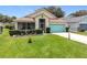 Inviting single-story home with a well-kept lawn and vibrant blue garage door at 4520 Eaglewood Dr, Leesburg, FL 34748