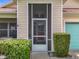 Welcoming front porch with a screen door and neatly trimmed hedges at 4520 Eaglewood Dr, Leesburg, FL 34748