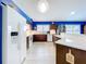 Bright kitchen features dark wood cabinets, light countertops, white appliances, and an open layout for easy entertaining at 4520 Eaglewood Dr, Leesburg, FL 34748