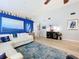 Well-lit living room with a large painting, modern furniture, and hardwood floors at 4520 Eaglewood Dr, Leesburg, FL 34748