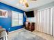 Living room featuring a wall-mounted TV and a shuttered window at 4520 Eaglewood Dr, Leesburg, FL 34748
