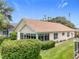 Well-maintained home featuring a screened lanai and manicured landscaping at 4520 Eaglewood Dr, Leesburg, FL 34748
