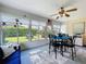 Inviting sunroom with ample natural light, a table and chairs, and a cozy blue sofa, perfect for relaxing at 4520 Eaglewood Dr, Leesburg, FL 34748