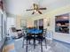 Well-lit sunroom featuring a table and chairs, a recliner, and a view into the kitchen and living spaces at 4520 Eaglewood Dr, Leesburg, FL 34748