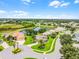 Beautiful aerial shot of a lush green neighborhood surrounding a tranquil lake and green field at 5620 Illumination Ln, Leesburg, FL 34748