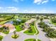 An aerial view of a beautiful residential community with homes surrounding lakes and winding streets at 5620 Illumination Ln, Leesburg, FL 34748