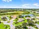 Residential homes in community surrounded by green spaces, bodies of water, and neighborhood streets at 5620 Illumination Ln, Leesburg, FL 34748
