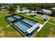 Aerial view of the community pickle ball and tennis courts with seating and shuffleboard at 5620 Illumination Ln, Leesburg, FL 34748