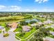 Beautiful aerial view of a home on a lush green lawn next to a serene lake at 5620 Illumination Ln, Leesburg, FL 34748