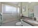 Well-maintained bathroom featuring a shower with glass doors and a vanity with a sink at 5620 Illumination Ln, Leesburg, FL 34748