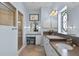 Elegant bathroom with a separate shower, vanity area, and a decorative stained glass window at 5620 Illumination Ln, Leesburg, FL 34748