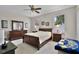 Bright bedroom with matching furniture, including a dresser, nightstands, and a comfortable bed at 5620 Illumination Ln, Leesburg, FL 34748