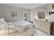 Tranquil bedroom with a large dresser, soft carpet, and private access to outdoor space at 5620 Illumination Ln, Leesburg, FL 34748
