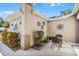 Enclosed patio area with potted plants, decorative wall art, and a cozy outdoor seating area at 5620 Illumination Ln, Leesburg, FL 34748