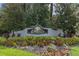 Legacy of Leesburg community entrance sign surrounded by colorful flower beds and mature trees at 5620 Illumination Ln, Leesburg, FL 34748