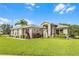 Charming single-story home with a manicured lawn, mature landscaping, and inviting entryway at 5620 Illumination Ln, Leesburg, FL 34748