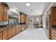 Open kitchen with ample cabinet space, stainless steel appliances, and views to dining and living spaces at 5620 Illumination Ln, Leesburg, FL 34748