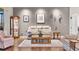 Inviting living room featuring a neutral palette, elegant decor, hardwood floors, and natural light at 5620 Illumination Ln, Leesburg, FL 34748