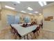 Spacious meeting room with tables, chairs, and natural light, perfect for community gatherings and events at 5620 Illumination Ln, Leesburg, FL 34748