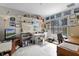 Cluttered office space with a desk, shelves, and a window offering natural light at 5620 Illumination Ln, Leesburg, FL 34748