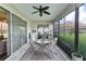 Enclosed patio with tile flooring, a ceiling fan, and comfortable seating for outdoor enjoyment at 5620 Illumination Ln, Leesburg, FL 34748