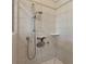 Tiled shower stall featuring an adjustable shower head and built-in shelving at 5620 Illumination Ln, Leesburg, FL 34748