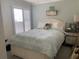 Relaxing bedroom with light blue walls, white furniture, and bright natural light at 627 Nuevo Leon Ln, The Villages, FL 32159