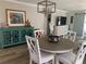 Inviting dining area with stylish light fixture, attractive decor, and wood-look flooring at 627 Nuevo Leon Ln, The Villages, FL 32159