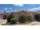Charming home featuring a well-manicured yard with lush landscaping and vibrant flowers at 627 Nuevo Leon Ln, The Villages, FL 32159