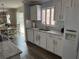 Bright kitchen with white cabinets, granite countertops, stainless appliances, and an eat-in area at 627 Nuevo Leon Ln, The Villages, FL 32159