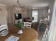 Open floorplan showcasing living and dining areas with sliding barn doors to sunroom at 627 Nuevo Leon Ln, The Villages, FL 32159