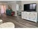 Bright living room featuring modern decor, wood-look flooring, and a decorative console at 627 Nuevo Leon Ln, The Villages, FL 32159
