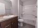 Clean bathroom features a vanity with granite counters, a toilet, and a shower-tub combo at 8161 Cr 647, Bushnell, FL 33513
