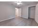 A spacious bedroom with walk-in closet, an en-suite bathroom, and gray wood-look flooring at 8161 Cr 647, Bushnell, FL 33513