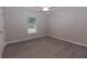 Bedroom with window, ceiling fan, and gray wood-look flooring offers a bright, inviting atmosphere at 8161 Cr 647, Bushnell, FL 33513