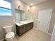 Bathroom featuring double sinks, cabinetry, and a large mirror at 8949 Sw 76Th St, Ocala, FL 34481